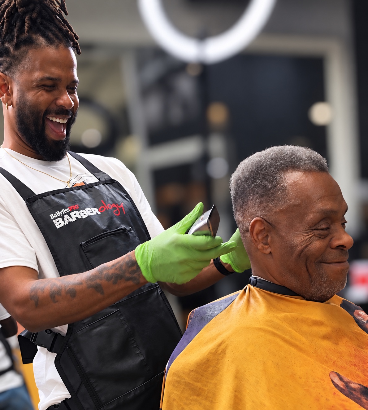 Omar cutting a client’s hair at Redds Barber Salon